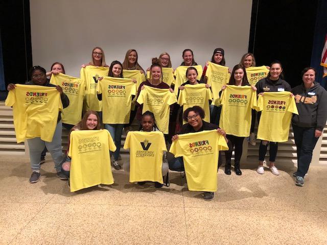 Social Work students posing with their Friends Club shirts